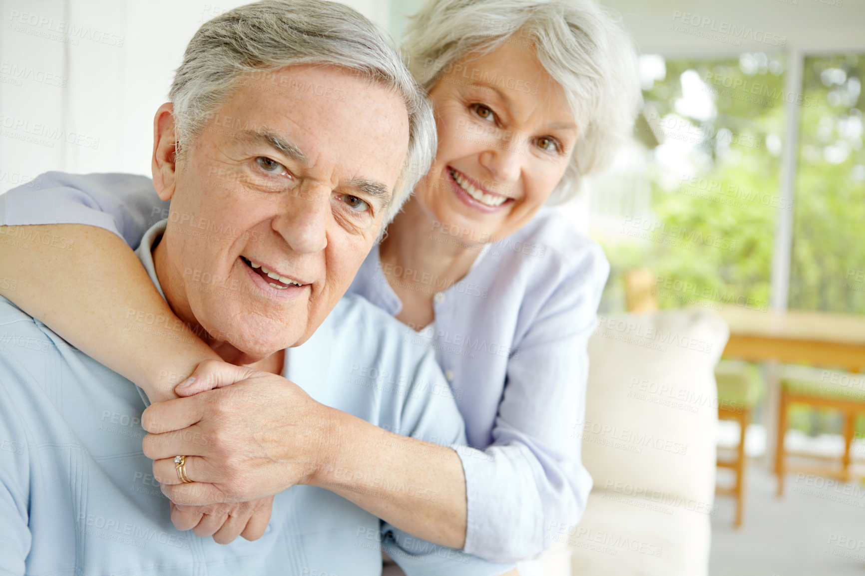 Buy stock photo Hug, love and portrait of senior couple on sofa in living room of home together for bonding or commitment. Face, retirement or smile of old man and woman embracing in apartment for security or trust