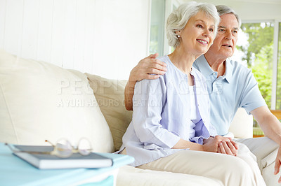 Buy stock photo Hug, relax and watching tv with senior couple on sofa in living room of home for subscription service. Love, smile or wellness with happy old man and woman in apartment for entertainment or streaming