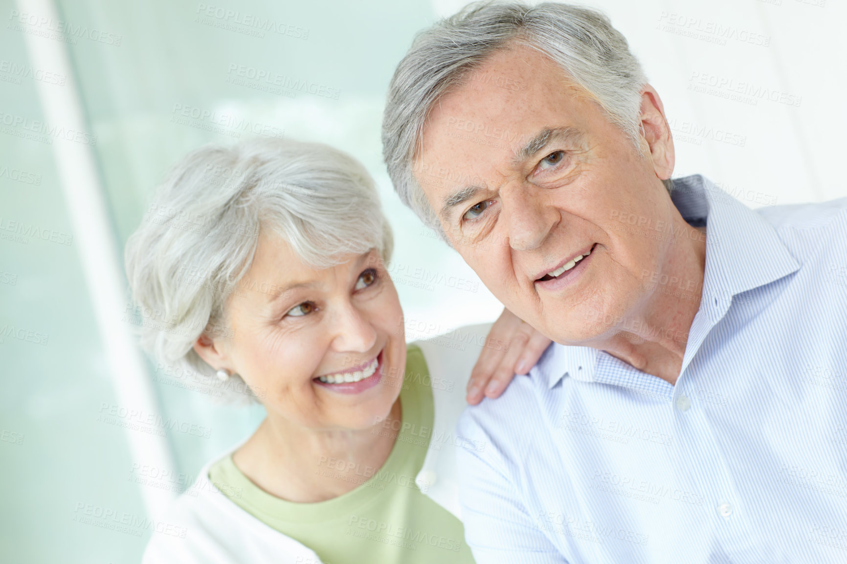 Buy stock photo Happy, portrait and senior couple in home with smile for romantic connection on weekend together. Elderly man, woman and relax with love in house for retirement support, joy and bonding in marriage