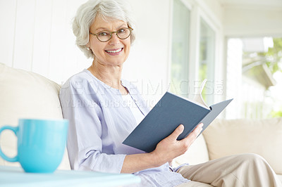 Buy stock photo Elderly woman, portrait and reading book on sofa for relax in retirement home on weekend or break. Senior, female person and glasses as confident, happy and calm in living room on couch for knowledge