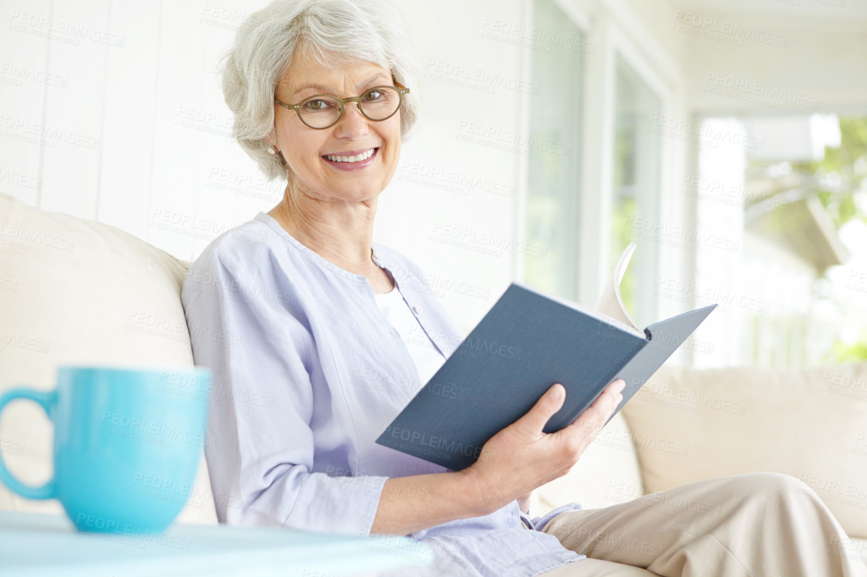 Buy stock photo Elderly woman, portrait and reading book on sofa for relax in retirement home on weekend or break. Senior, female person and glasses as confident, happy and calm in living room on couch for knowledge