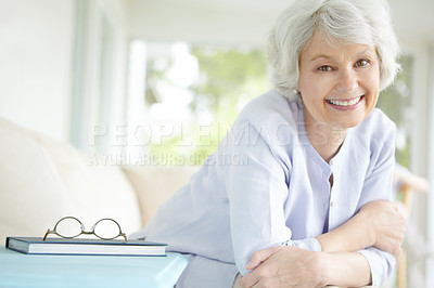 Buy stock photo Elderly woman, portrait and relax in home on sofa for retirement, good health and weekend with break. Senior female, smile and healthy person on pension for positive mood, comfort and peace on couch