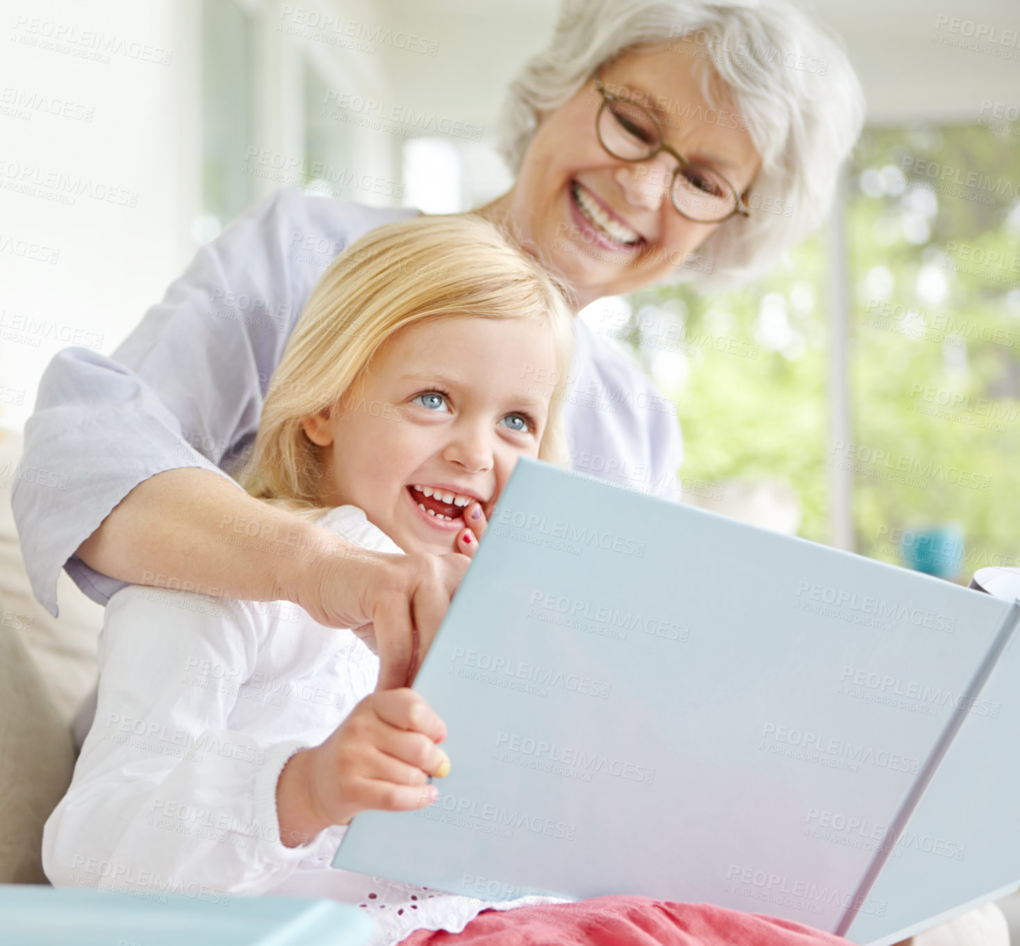 Buy stock photo Grandma, smile and girl reading book in home for learning, bonding and knowledge together. Grandmother, senior woman and kid storytelling in family house for fairytale, fantasy or child development