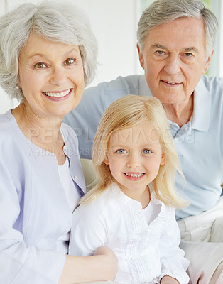 Buy stock photo Grandparents, portrait and happy in home with girl for bonding, care and weekend visit on sofa. Elderly people, face and family in living room with little child for relax, support and connection