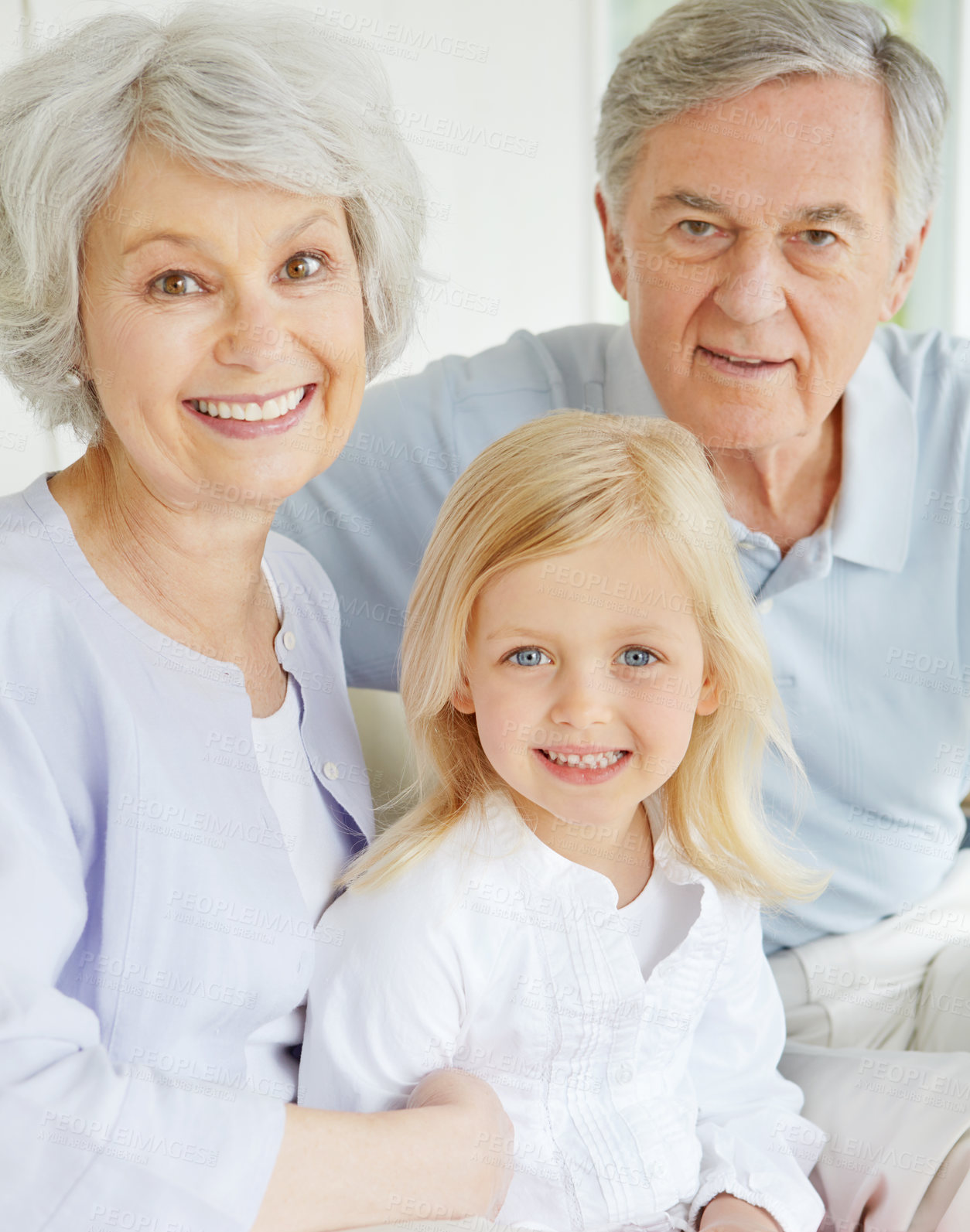 Buy stock photo Grandparents, portrait and happy in home with girl for bonding, care and weekend visit on sofa. Elderly people, face and family in living room with little child for relax, support and connection