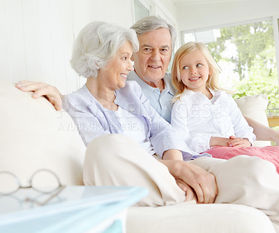 Buy stock photo Senior man, woman and child in family home or lounge as grandparents with happiness for bonding. Elderly people, little girl and together for love in living room or house for growth, support and care