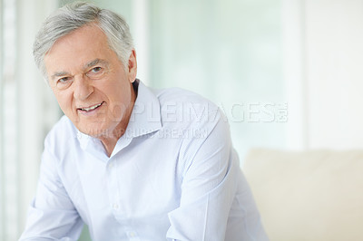 Buy stock photo Portrait, relax and smile with senior man on sofa in living room of home for comfort or rest. Happy, retirement and wellness with face of confident mature person in apartment for weekend time off