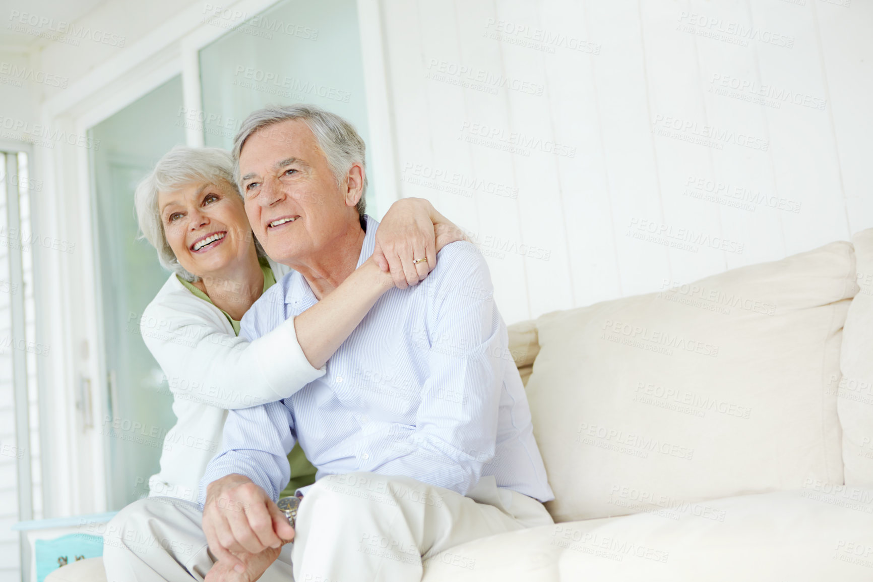 Buy stock photo Happy, thinking and senior couple on sofa with smile for marriage connection on weekend together. Elderly woman, man and home with hug in love for retirement support, joy and bonding in romance