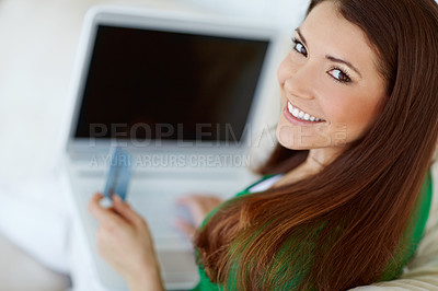 Buy stock photo Portrait of a beautiful young woman shopping online from the comfort of home