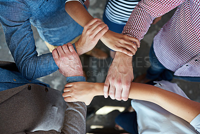 Buy stock photo Top view of co-workers hand put together in an expression of unity and team spirit
