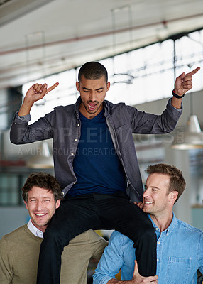 Buy stock photo Two coworkers lifting up a third on their shoulders
