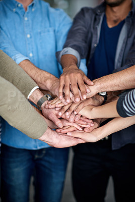 Buy stock photo Cropped view of a multi ethnic group putting their hands together in unity