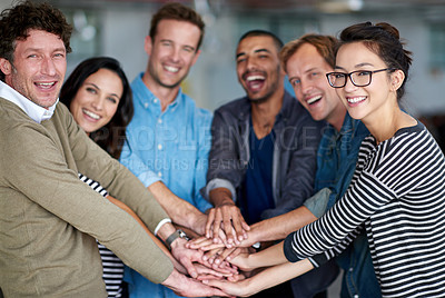 Buy stock photo Portrait of happy group of coworkers holding their hands together in unity