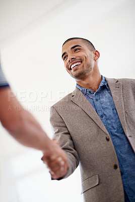 Buy stock photo Low angle shot of two colleagues shaking hands