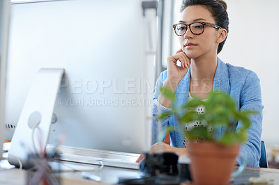 Buy stock photo Professional young woman thinking while looking at the screen of her pc in her office