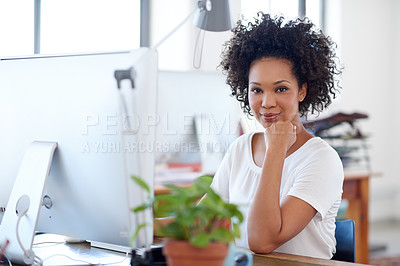 Buy stock photo Confident businesswoman looking at the camera while sitting in her office