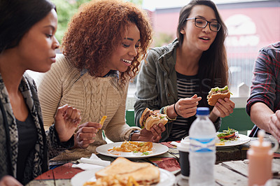 Buy stock photo Restaurant, group and friends eating, social gathering and reunion with conversation and happiness. Diversity, women and student on a break, fast food and snack with lunch and smile with discussion