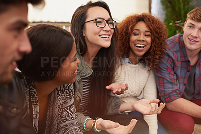Buy stock photo Cropped shot of a group of friends laughing and having a good time