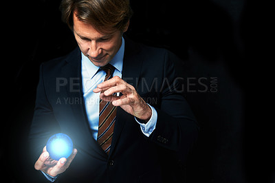 Buy stock photo Businessman, globe and hologram for networking, global expansion and worldwide innovation in studio. Futuristic crystal, magic and professional man on black background, tech and connect for economy