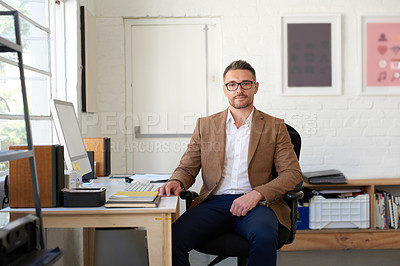 Buy stock photo Portrait of a handsome businessman working in his office