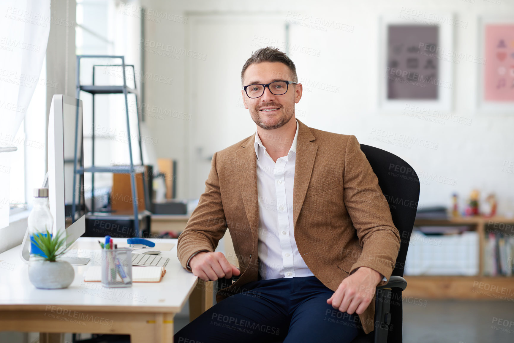 Buy stock photo Businessman, glasses and portrait in office, writer and smile for project, reporter and professional. Face, proud and entrepreneur in company, journalist and confidence in startup and computer