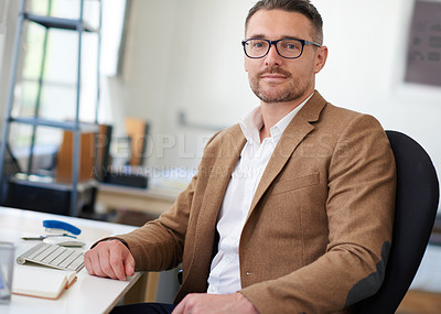 Buy stock photo Portrait of a handsome businessman working in his office