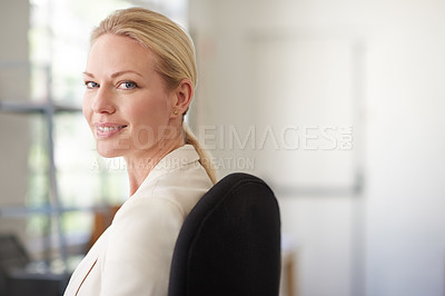 Buy stock photo Portrait of a beautiful businesswoman looking at the camera in a bright office space