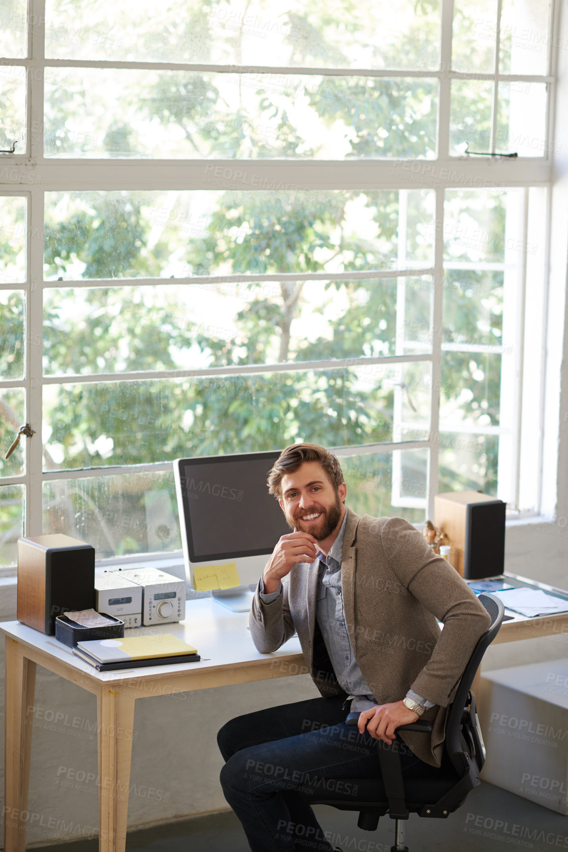 Buy stock photo Portrait of a handsome businessman working in his office