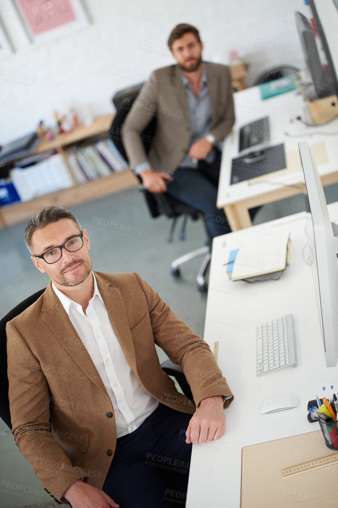 Buy stock photo Businessman, glasses and portrait in office, table and coworking of colleagues, computer and together. Above, working and entrepreneur in company, journalist and confidence in startup and creative