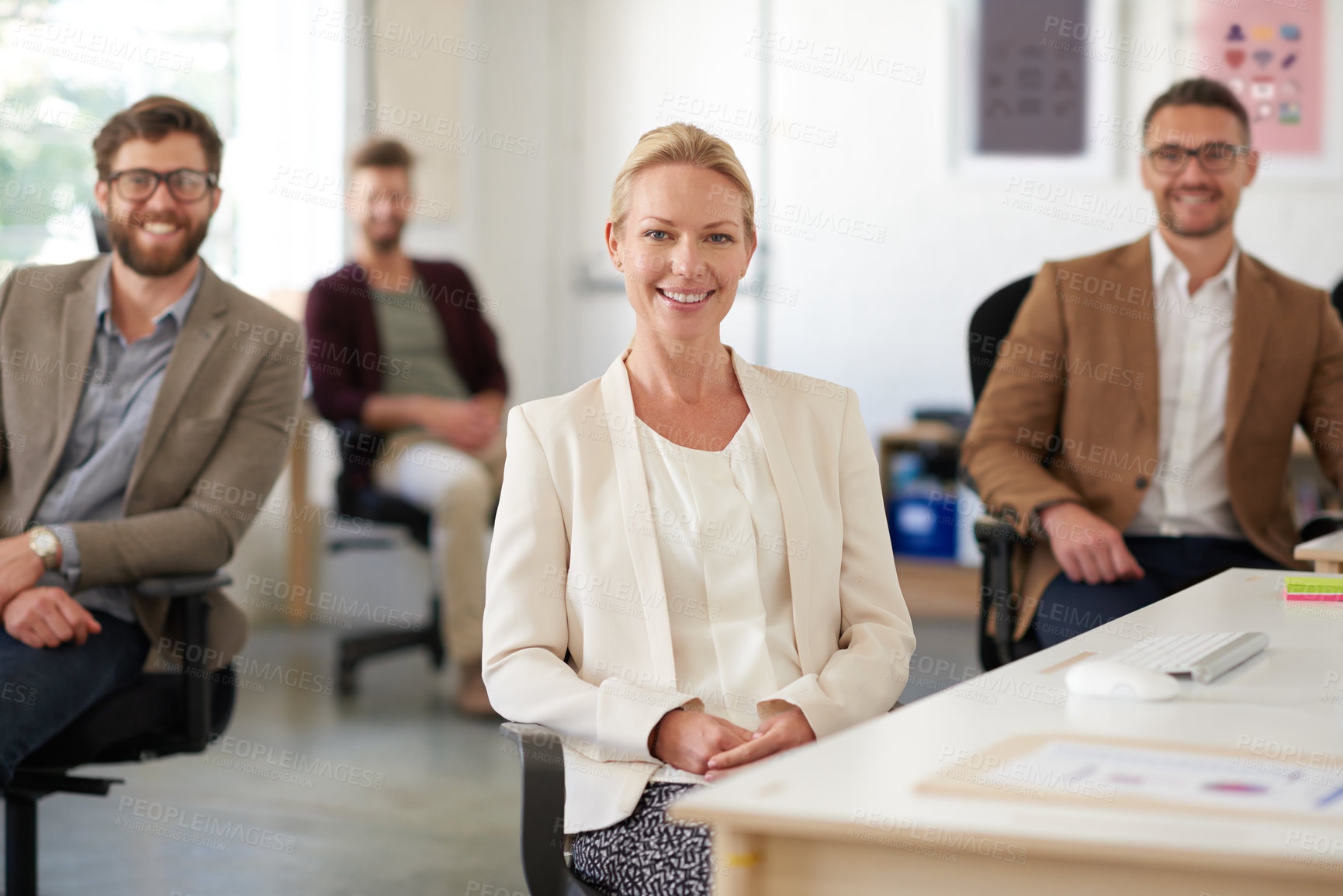 Buy stock photo Smiling creative professional woman with colleagues in the background
