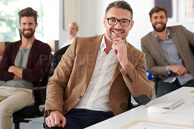 Buy stock photo Smiling mature professional with colleagues in the background
