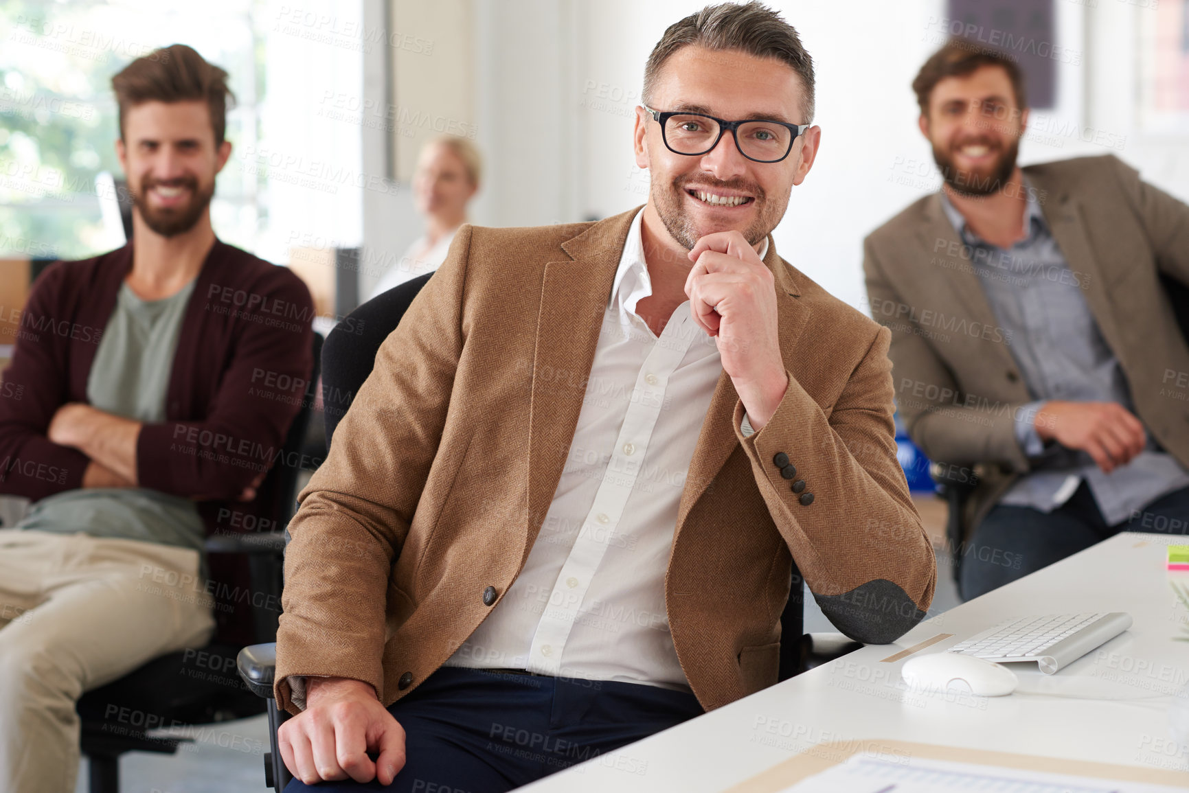 Buy stock photo Smiling mature professional with colleagues in the background
