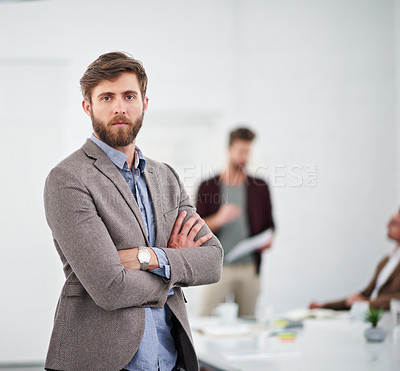 Buy stock photo Portrait of a young businessperson in a conference room with colleagues in the background