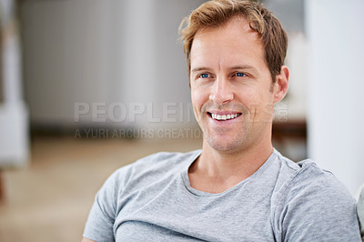 Buy stock photo Cropped shot of a handsome man relaxing at home