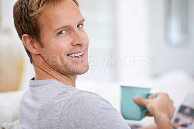 Buy stock photo Man, newspaper and portrait in home for coffee, calm and comfortable on weekend in living room. Male person, reading and article in apartment, information and drinking tea on couch for story update