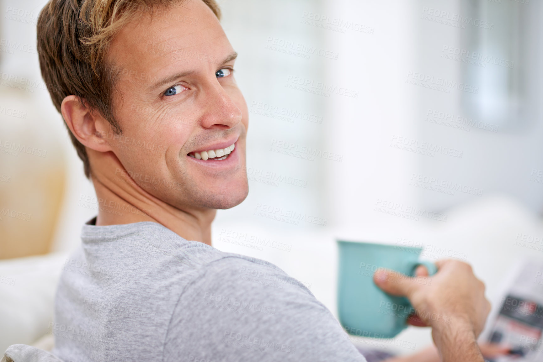 Buy stock photo Man, newspaper and portrait in home for coffee, calm and comfortable on weekend in living room. Male person, reading and article in apartment, information and drinking tea on couch for story update