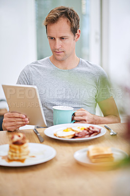 Buy stock photo Happy, man and breakfast with tablet at table for morning routine with rest, relax and entertainment on holiday at home. Online, male person and tech for watching tv or streaming movies on vacation