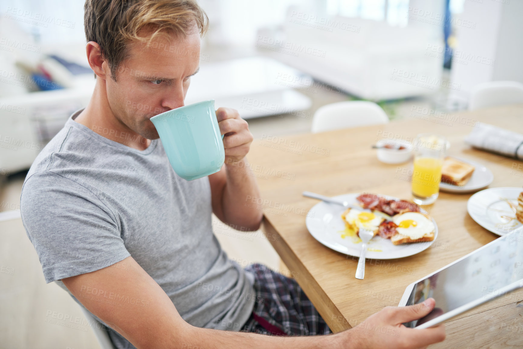 Buy stock photo Tablet, breakfast and man with coffee or news for reading info on elections to relax in morning. Home, tea or voter at brunch for healthy nutrition with online announcement, article or story update
