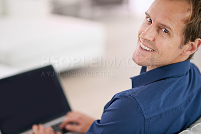 Buy stock photo Portrait of a handsome man using his laptop at home