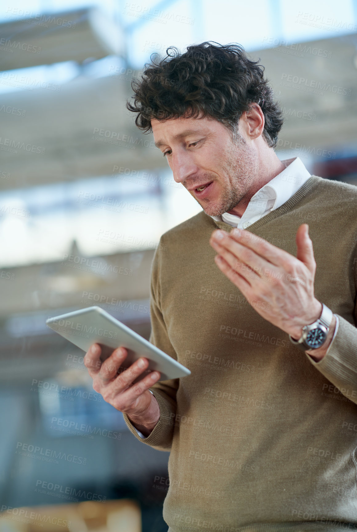 Buy stock photo Cropped shot of a casually-dressed businessman using a digital tablet