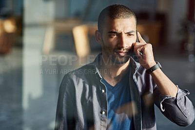 Buy stock photo Cropped shot of a young businessman talking on his mobile phone