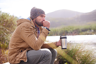 Buy stock photo Camping, cold and man with coffee by lake in nature for adventure, travel and outdoor vacation. Holiday, morning and male person with hot beverage for relax, peace and winter morning in countryside