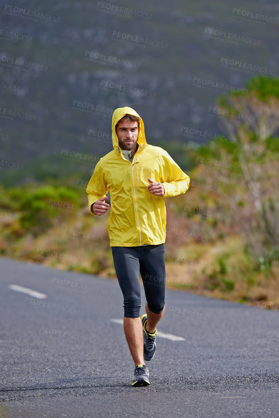 Buy stock photo Running, rain and man with challenge, fitness and endurance with workout and cardio. Road, runner and athlete with sports and training with wind and nature with exercise, coat or practice with health