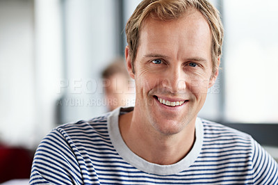 Buy stock photo Portrait of smiling man sitting in a casual work environment 
