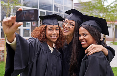 Buy stock photo Education, women celebrating graduation with selfie and group at the ceremony outside on campus. University or college academic achievement, female students take photo and people dressed in cloaks