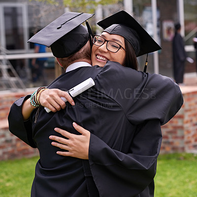 Buy stock photo Shot of two students hugging on graduation day