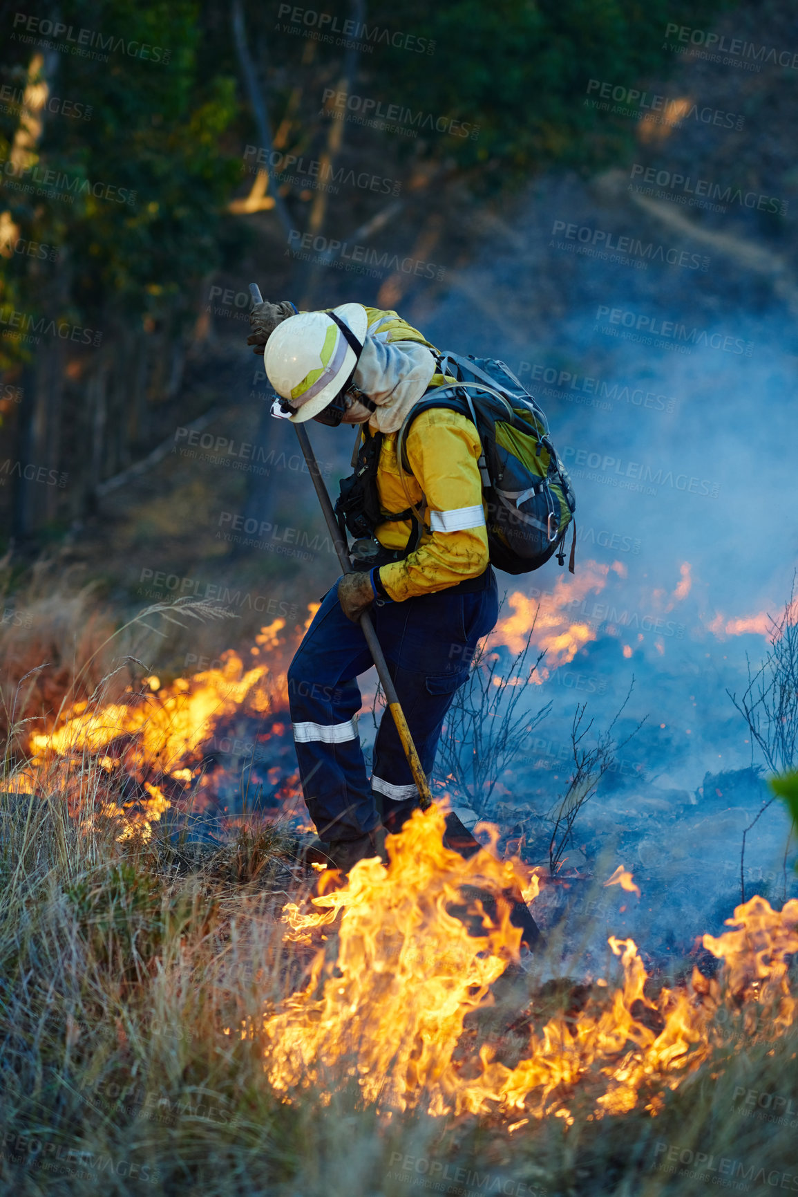 Buy stock photo Shot of fire fighters combating a wild fire