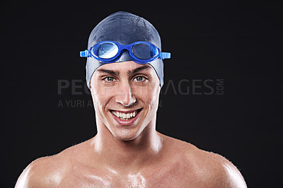 Buy stock photo Man, studio and portrait with swimmer smile, workout and exercise with athlete for cardio health. Wellness, confident and male person with swimming cap and goggles, black background for sport