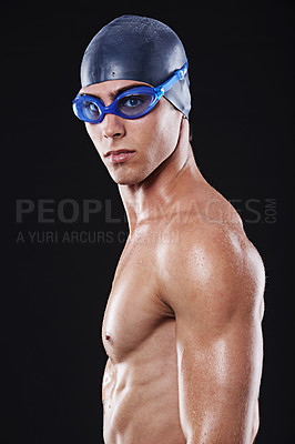 Buy stock photo Male, swimmer and face with goggles and cap for fitness, sport or exercise isolated in portrait. Serious, man and athlete with swimming training or cardio practice for competition on black background
