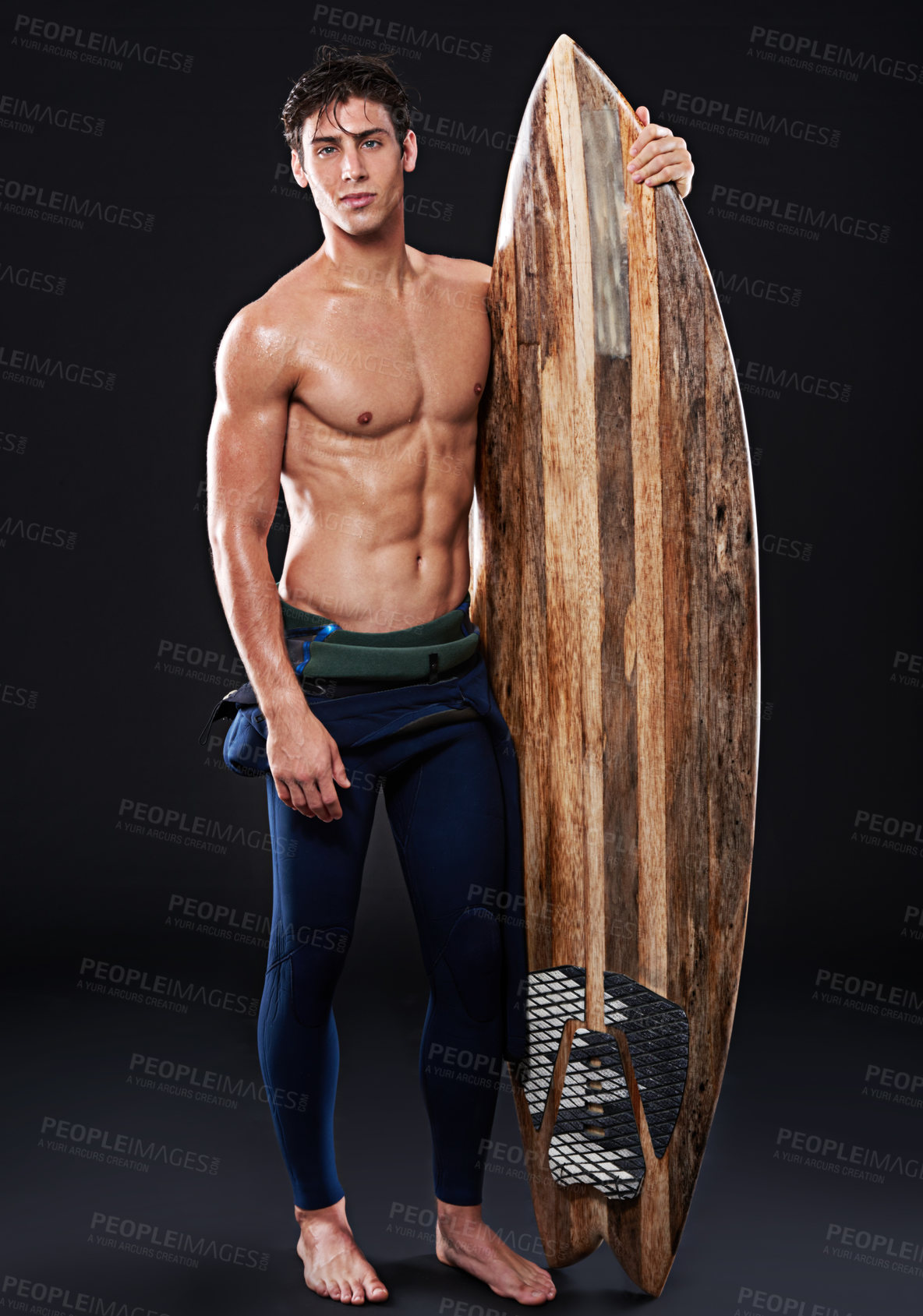 Buy stock photo Young surfer and retro board in studio and dark with body, stomach and strong or healthy. Male wave rider, backdrop or wood or vintage accessory in portrait for sports, fitness or confidence at night